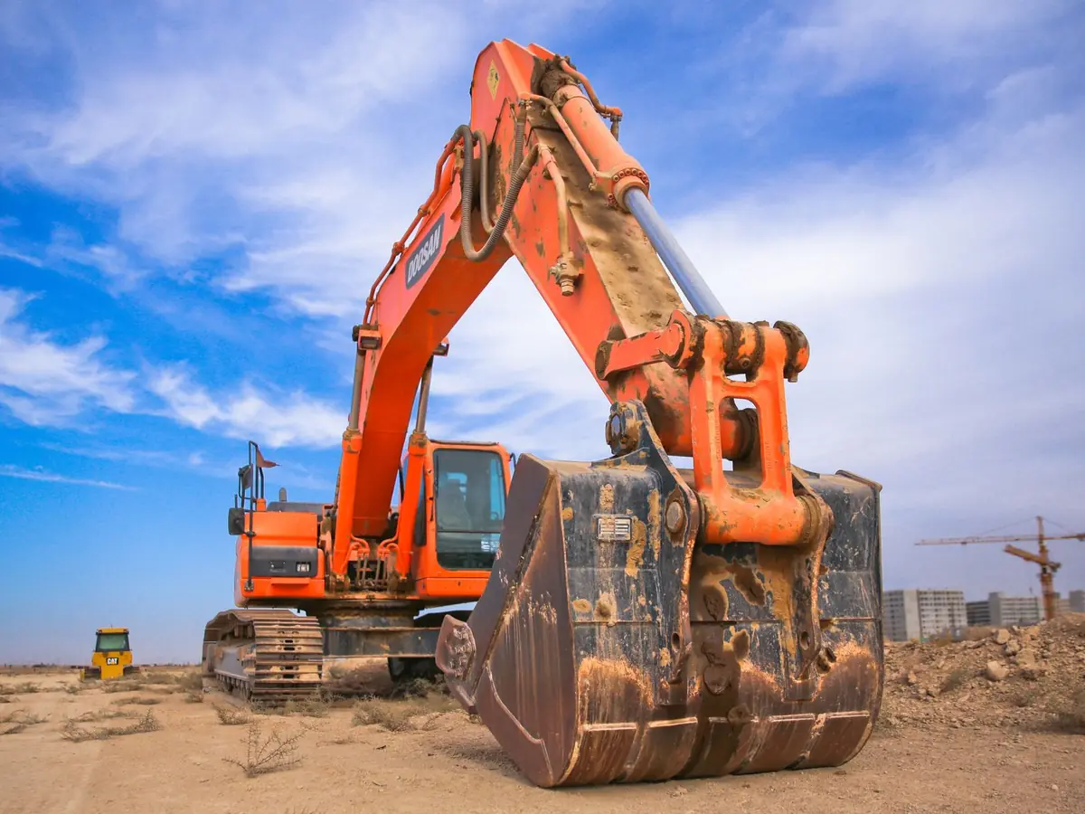 Placeholder photo: excavator bucket in the dirt. Not a Phil-dirt project.