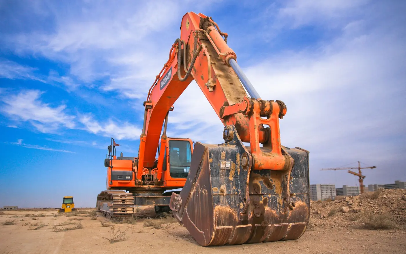 Placeholder photo: excavator bucket in the dirt. Not a Phil-dirt project.